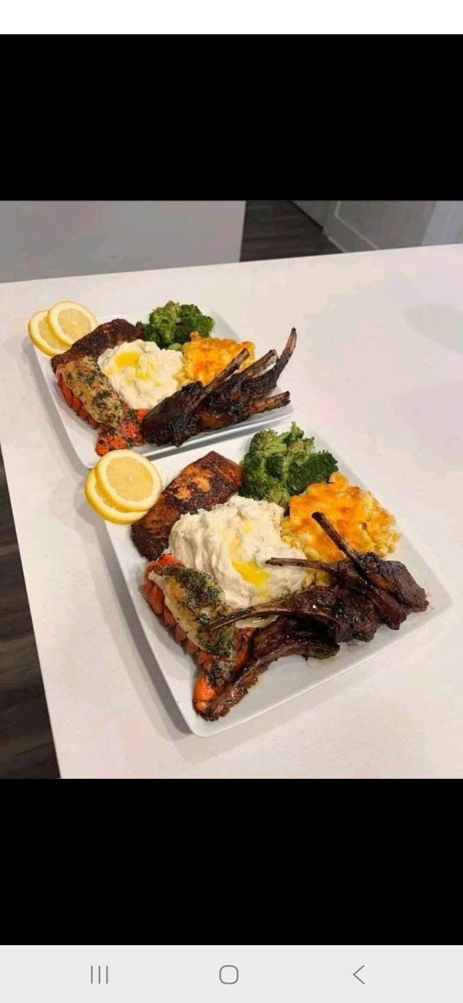 Lamb chops and seafood plates with vegetables and sides