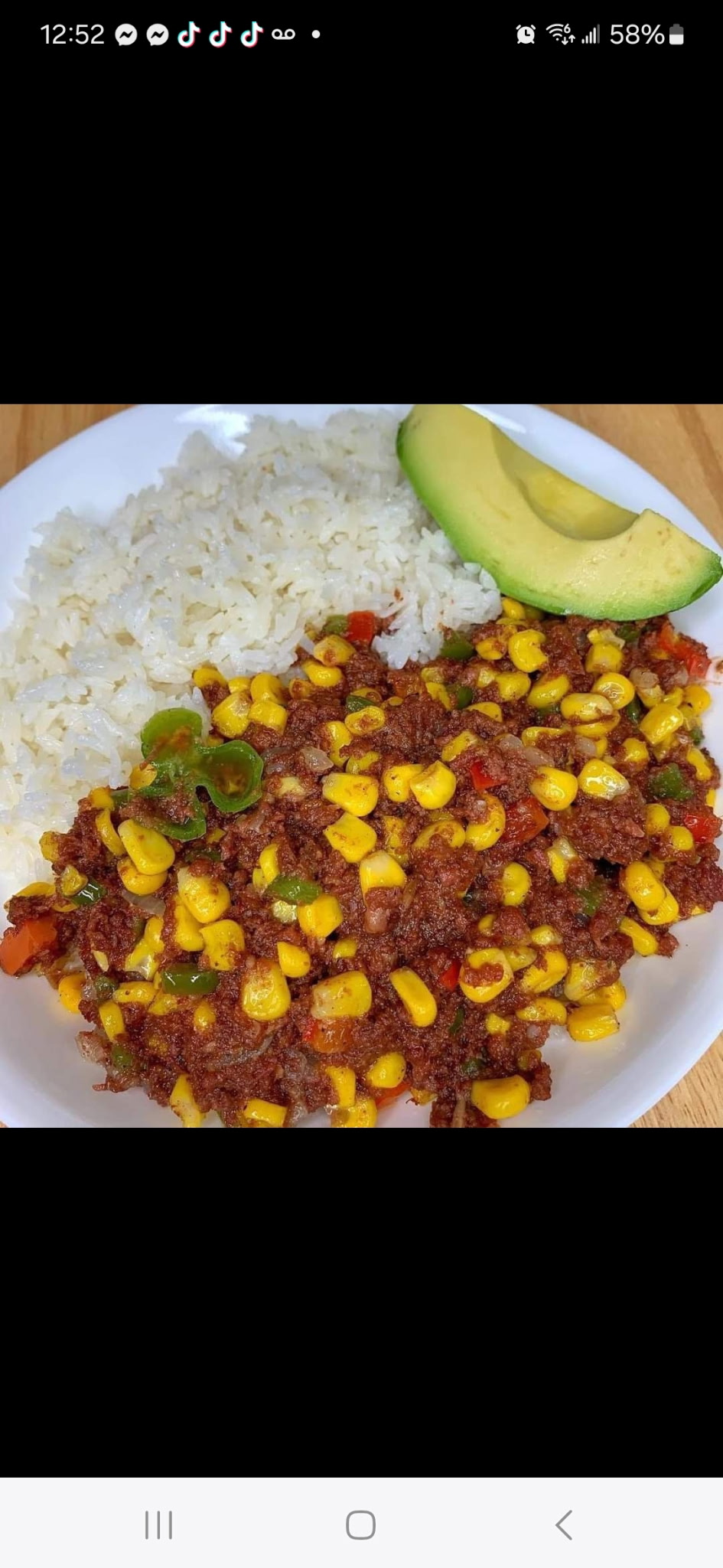 Rice with seasoned meat, corn and avocado