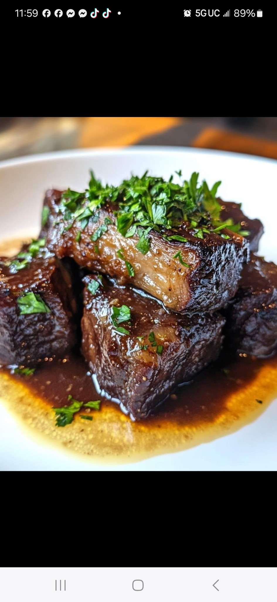 Braised meat topped with chopped herbs